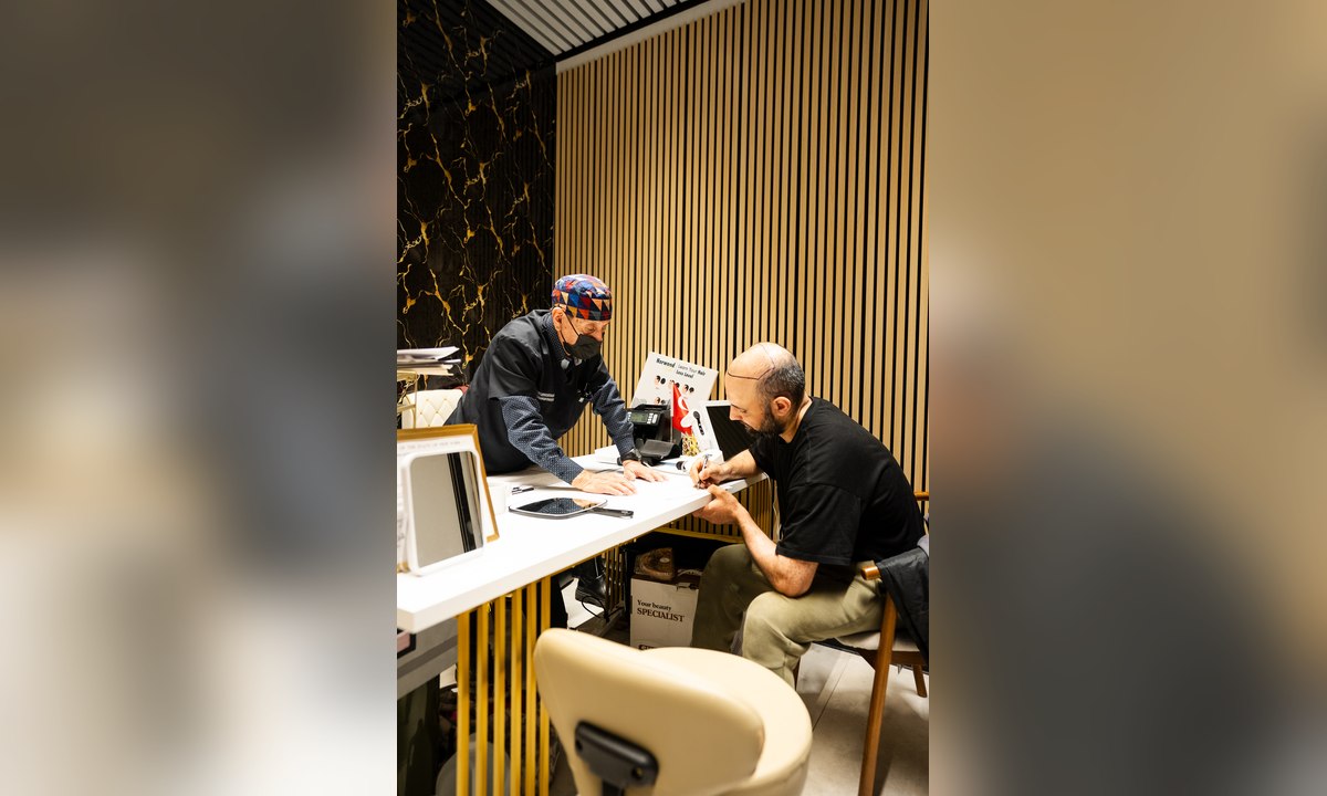 Peak clinician and patient reviewing a personalized hair restoration plan together