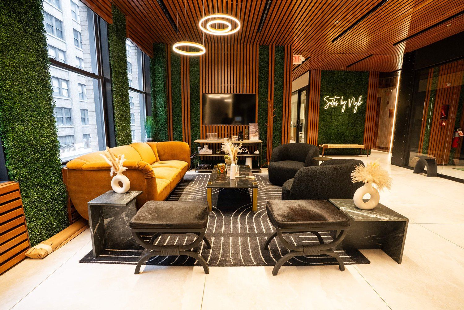 New York clinic lobby with seating, large windows and warm wood ceiling